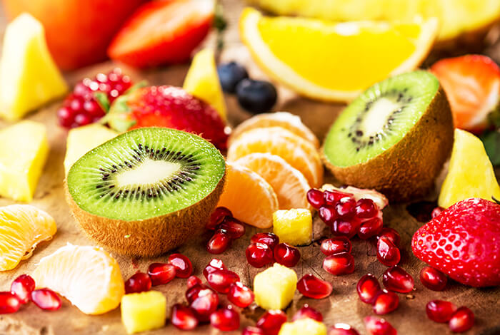 A variety of fruits spread on a smooth surface.