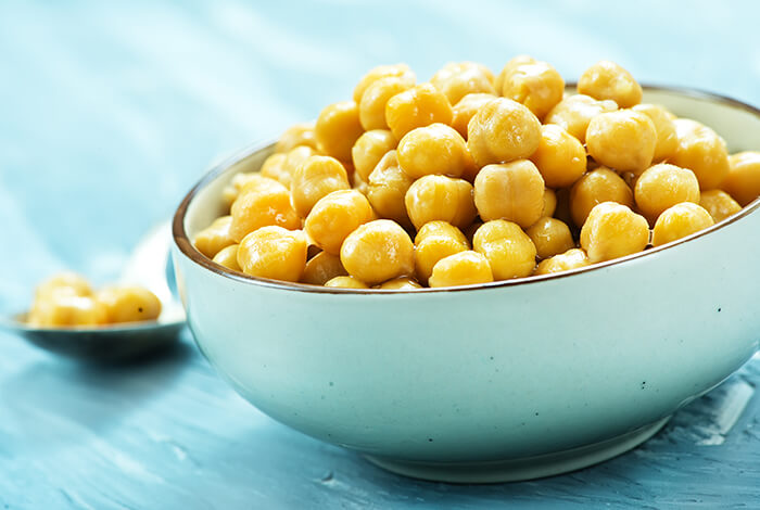 A bowl filled with cooked chickpeas.