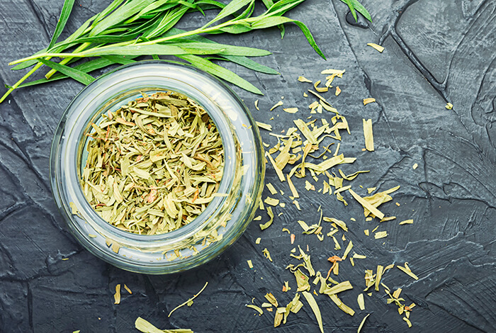 A jar filled with dried cilantro.