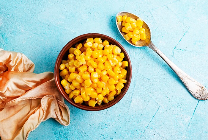 A bowl full of canned corn.