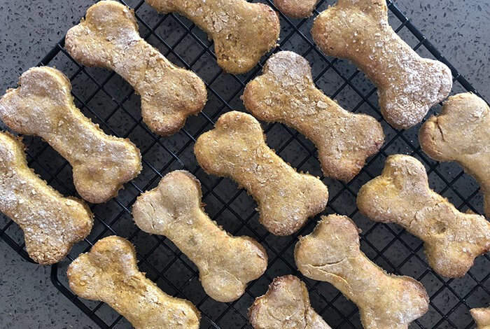 Corn dog treats on a cooling rack.