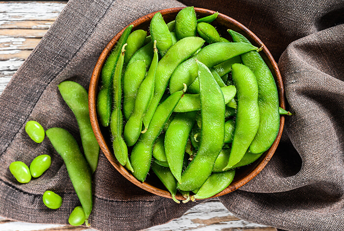 A bowl filled with edamame.
