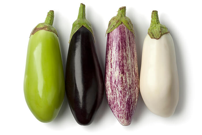 Different types of raw eggplants.