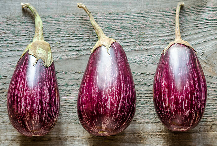 Three purple eggplants.