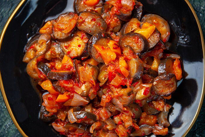 A plate full of cooked eggplant. 