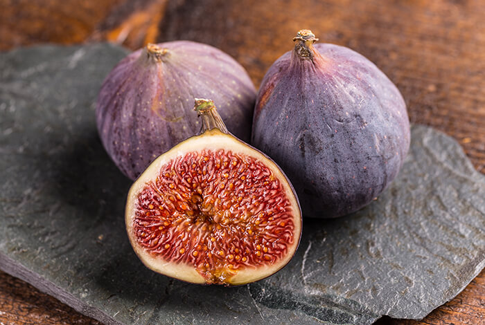 Three figs on a plate.