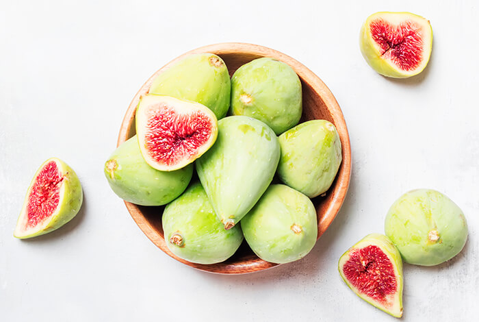 A bowl filled with young figs.