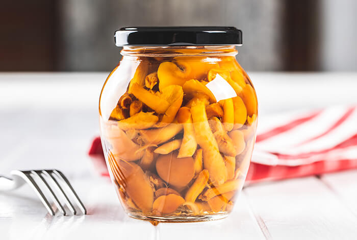 A bottle of preserved mushrooms.