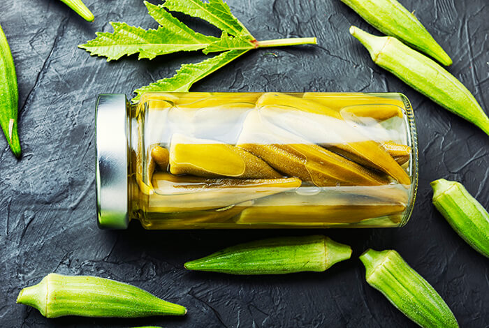 Preserved okra inside a glass container.