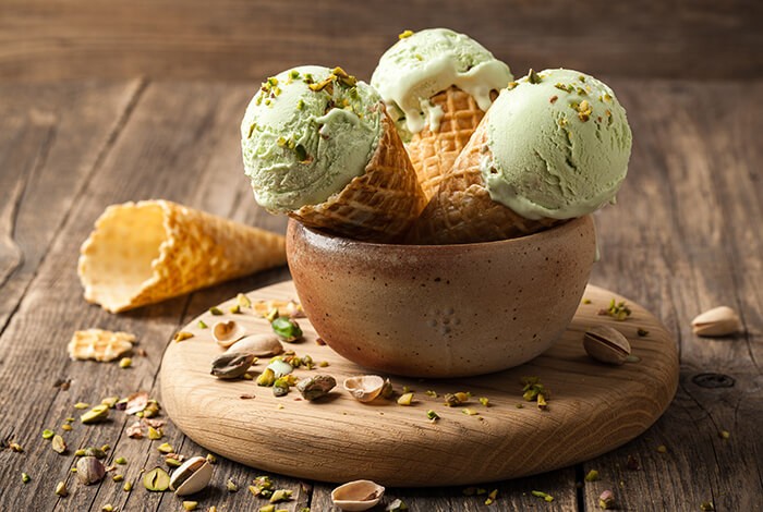 Pistachio ice cream on cones and placed in a bowl. 