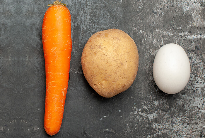 A potato, a carrot, and an egg.