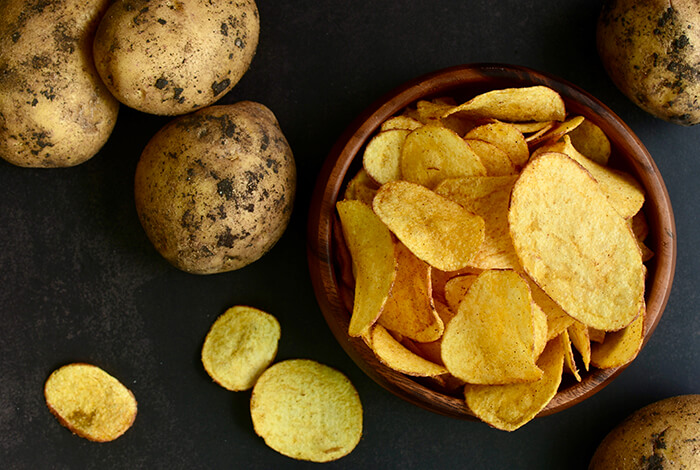 A bowl full of potato chips.