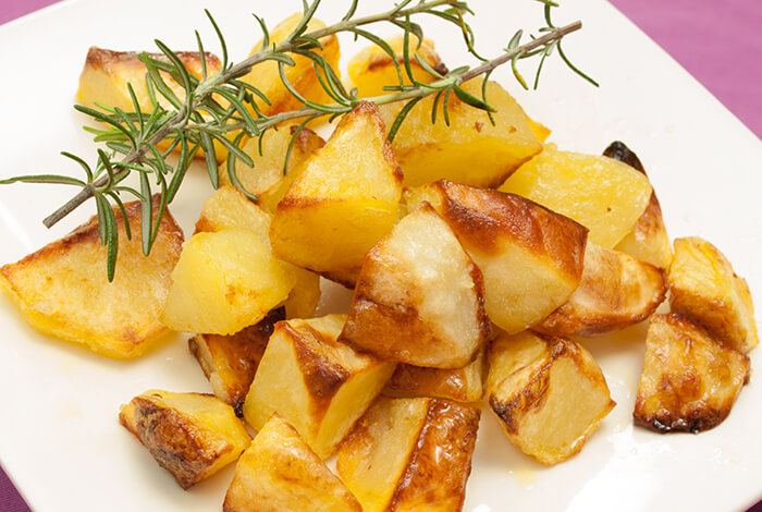 A plate full of baked potatoes.