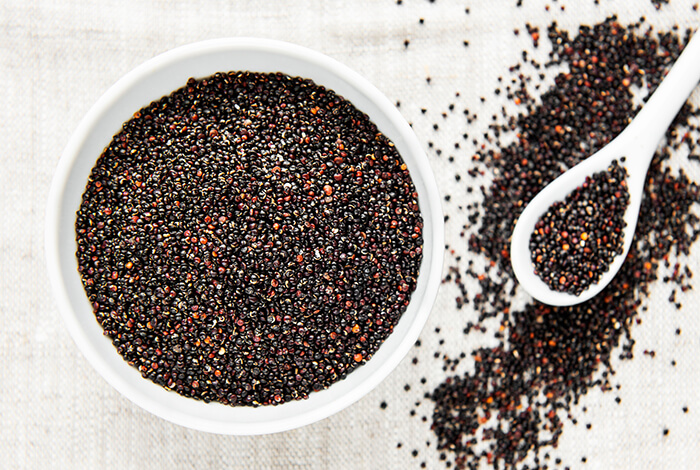 A black type of quinoa filled up a white bowl.