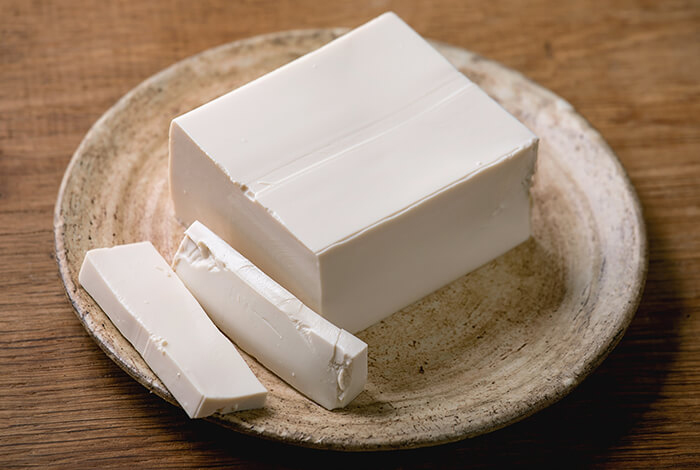 A block of tofu on a plate. 