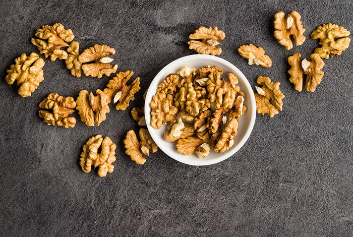 Walnuts in a white bowl.