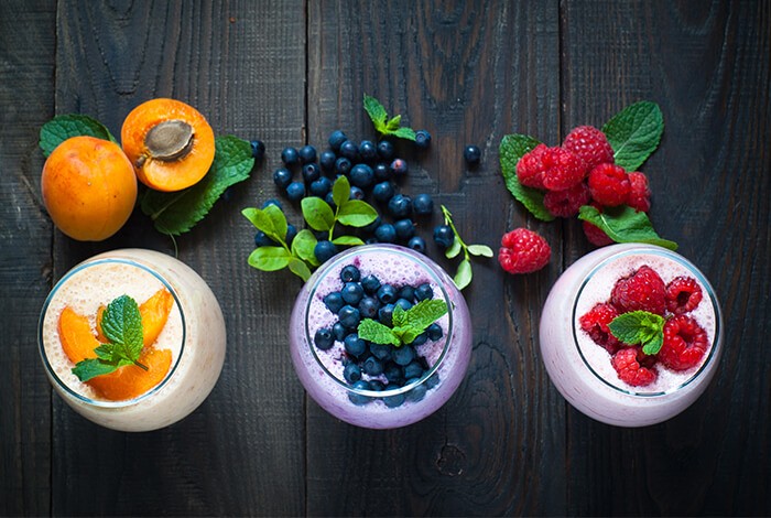 Jars filled with different fruit-flavored yogurts with real fruits.