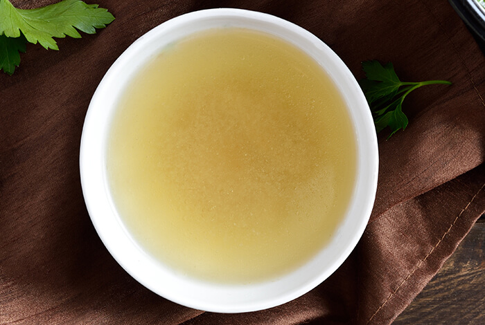 A bowl filled with clear broth.