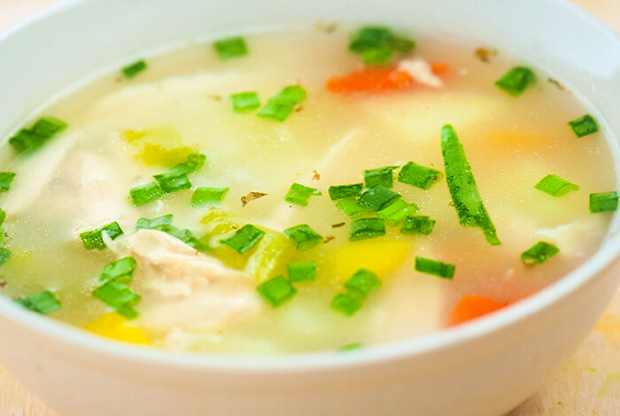 A bowl filled with chicken broth.