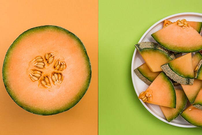 A cantaloupe sliced crosswise and a bowl of triangle-sliced cantaloupe 