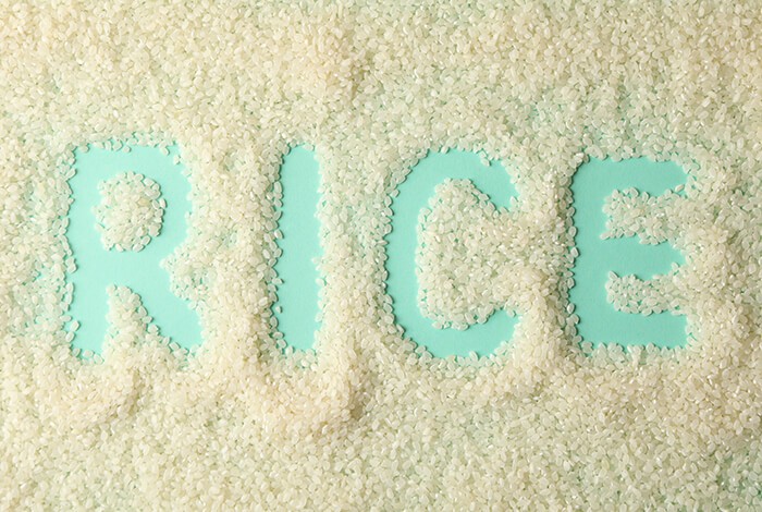 The spelling of RICE using uncooked white rice. 
