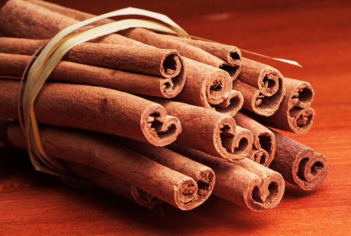 A closeup look at cinnamon sticks tied together.