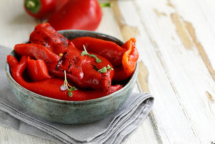 Roasted bell peppers fill up a bowl.