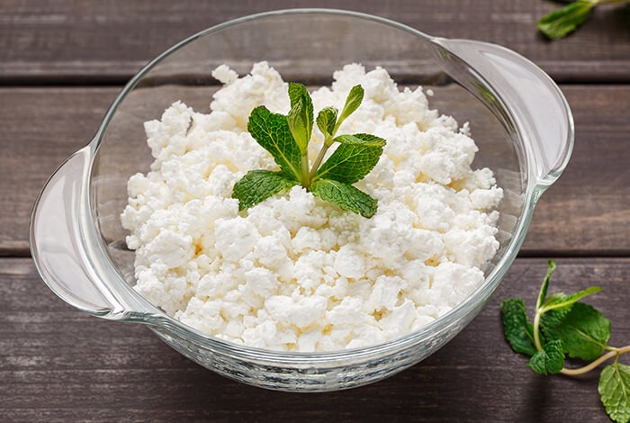 Cottage cheese placed in a glass bowl.