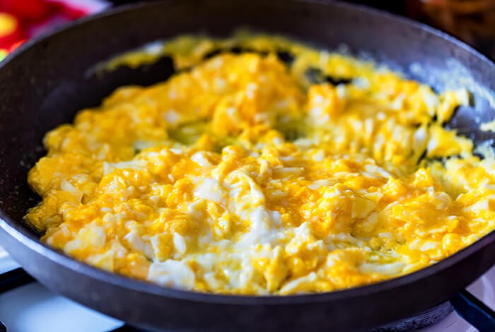 Scrambled eggs in a pan.