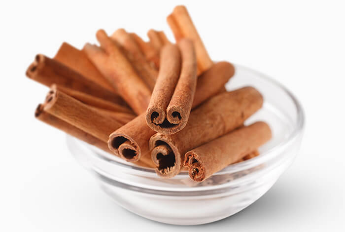 A bowl filled with cinnamon sticks.