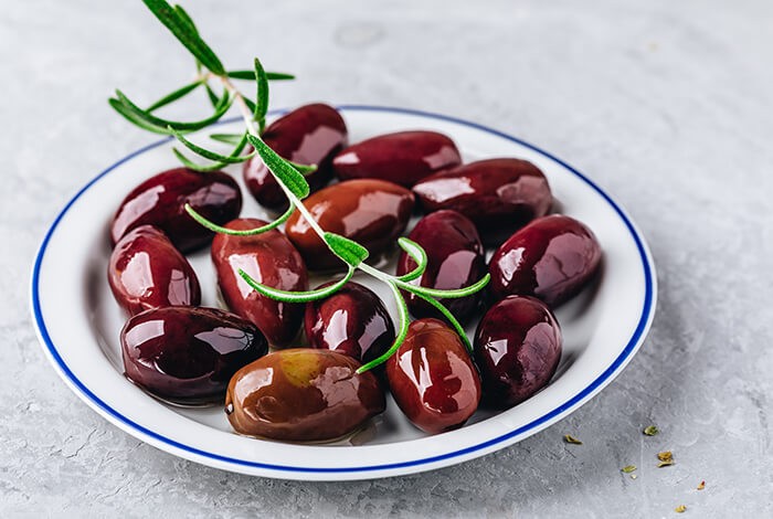 blackolives with olive oil and rosemary branch on