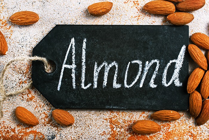 An almond tag surrounded by almonds.