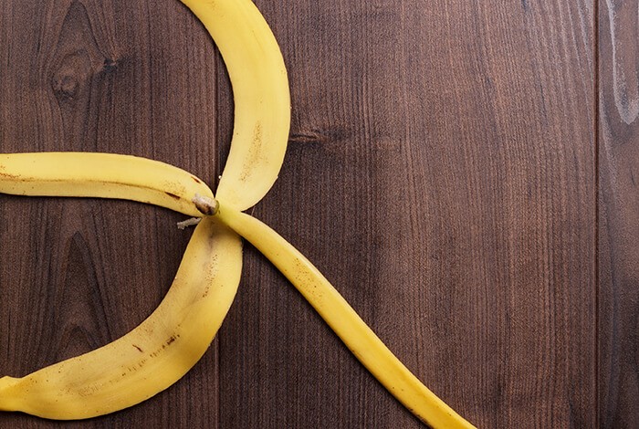 A banana peel on a wooden surface.