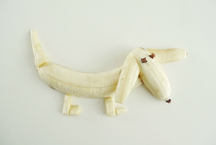 Peeled bananas formed into a dog.