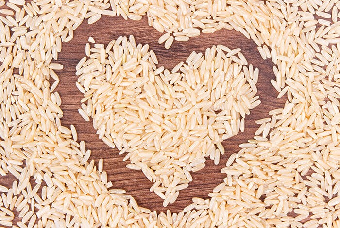 Uncooked brown rice formed into a heart.