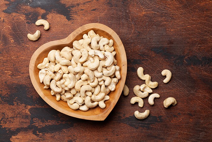 A heart-shaped bowl with cashews.