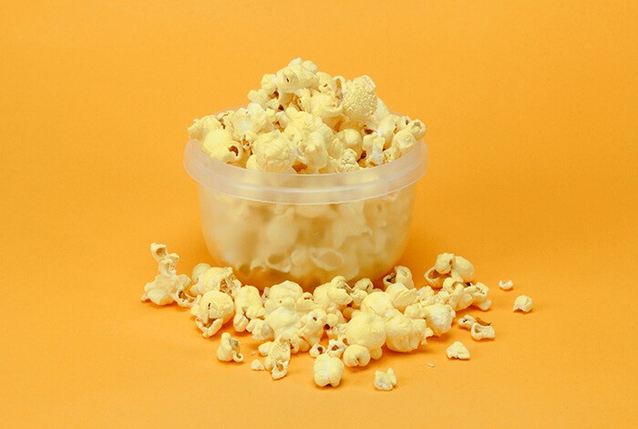 White cheddar popcorn placed on a clear container. 