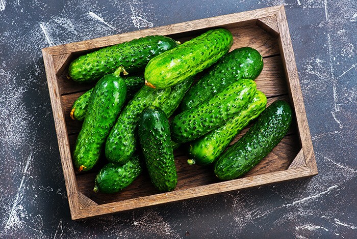 Cucumbers on a rectangular wooden box.