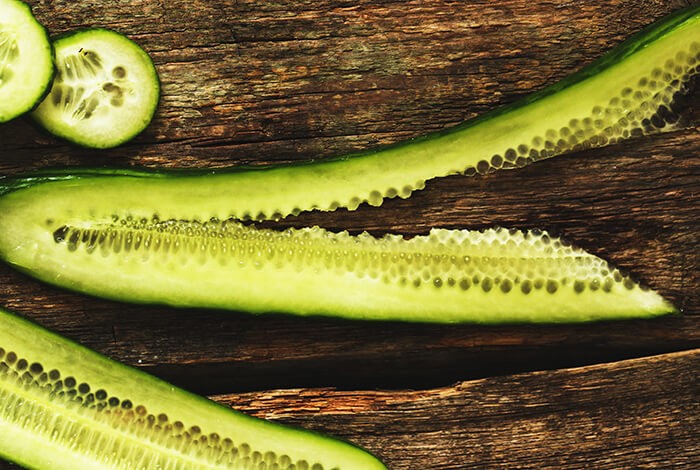 A cucumber cut lengthwise.