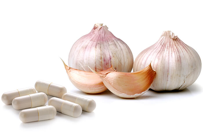 Garlic and garlic supplement capsules.