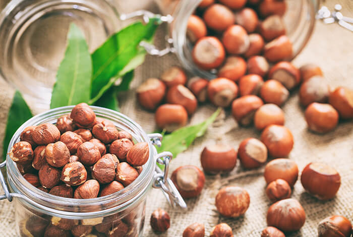 Glass containers full of hazelnuts.