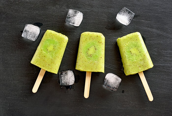 Three pieces of kiwi pupsicles and some ice cubes.
