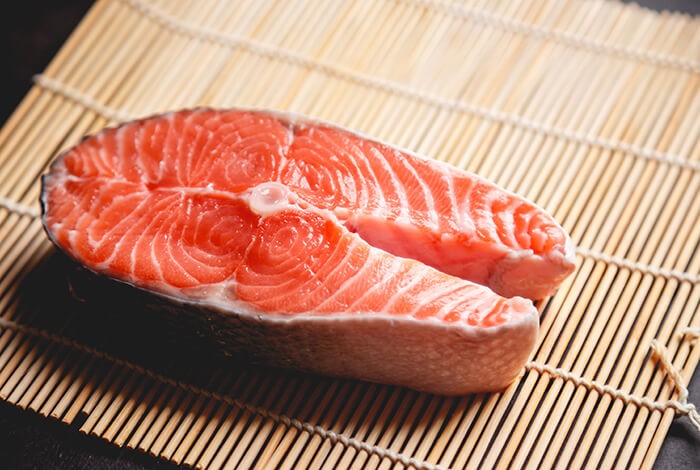 A slice of raw salmon for dogs.