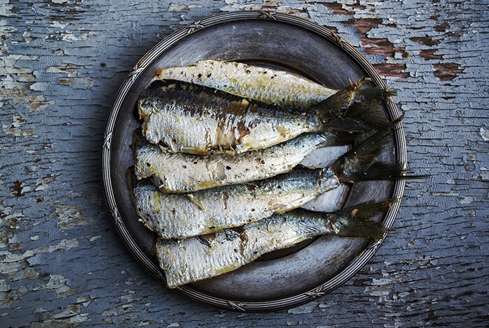 Cooked sardines on a plate.