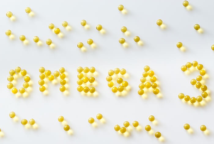 Capsules of fish oil for dogs that spell omega 3. 