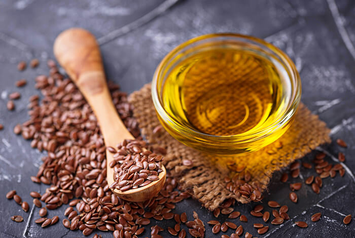 Flaxseeds and a bowl of flaxseed oil.