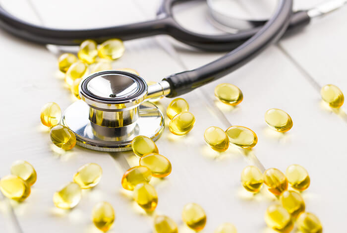 Scattered fish oil capsules for dogs and a stethoscope. 