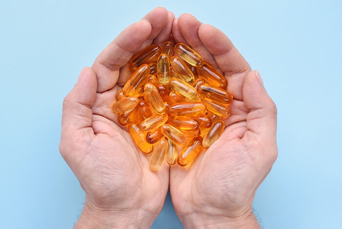 Fish oil for dogs on bare hands.