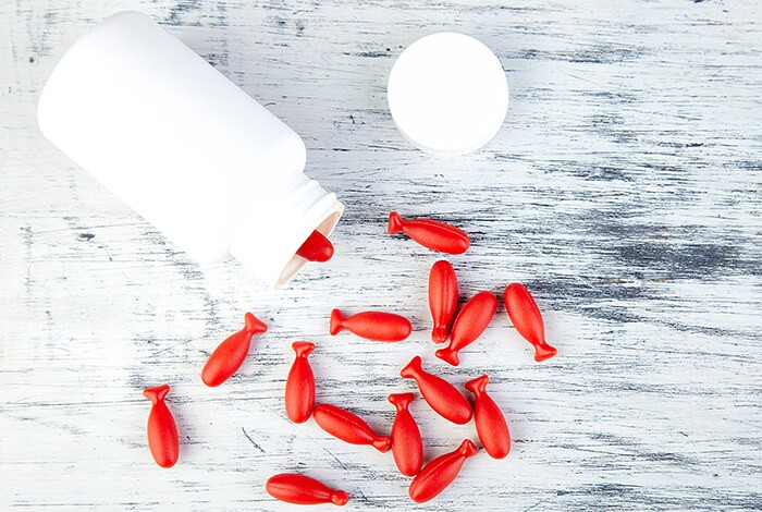 Fish-shaped capsules scattered on a surface.