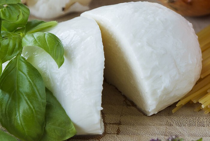 Mozzarella cheese with basil and uncooked pasta.